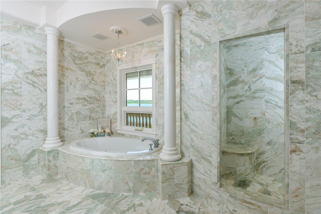137 High Hill Road Tiverton, RI 02878 - Photo 26 of 39 The master suite contains two bathrooms - his and hers. Absolutely stunning marble and custom chandeliers add a touch of luxury.