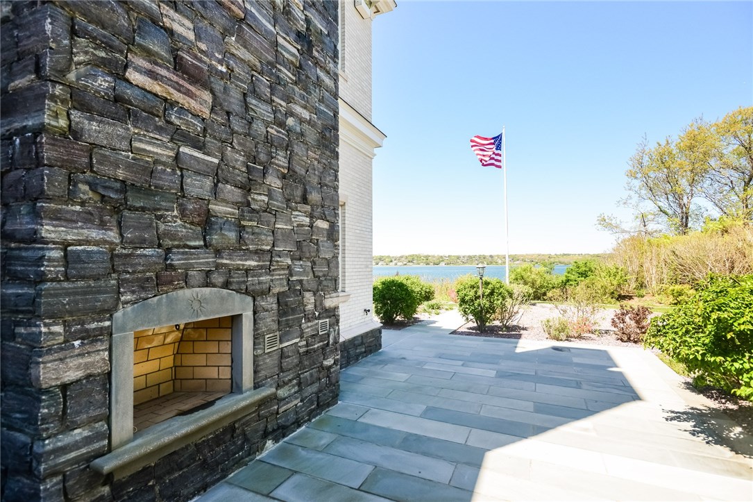 137 High Hill Road Tiverton, RI 02878 - Photo 35 of 39 Bluestone patio with fireplace overlooking the water.