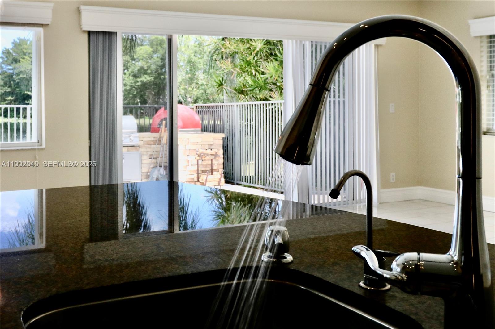 2686 Palmer Place Weston, FL 33332 - Photo 20 of 42 View outside and access to the BBB area from the kitchen
