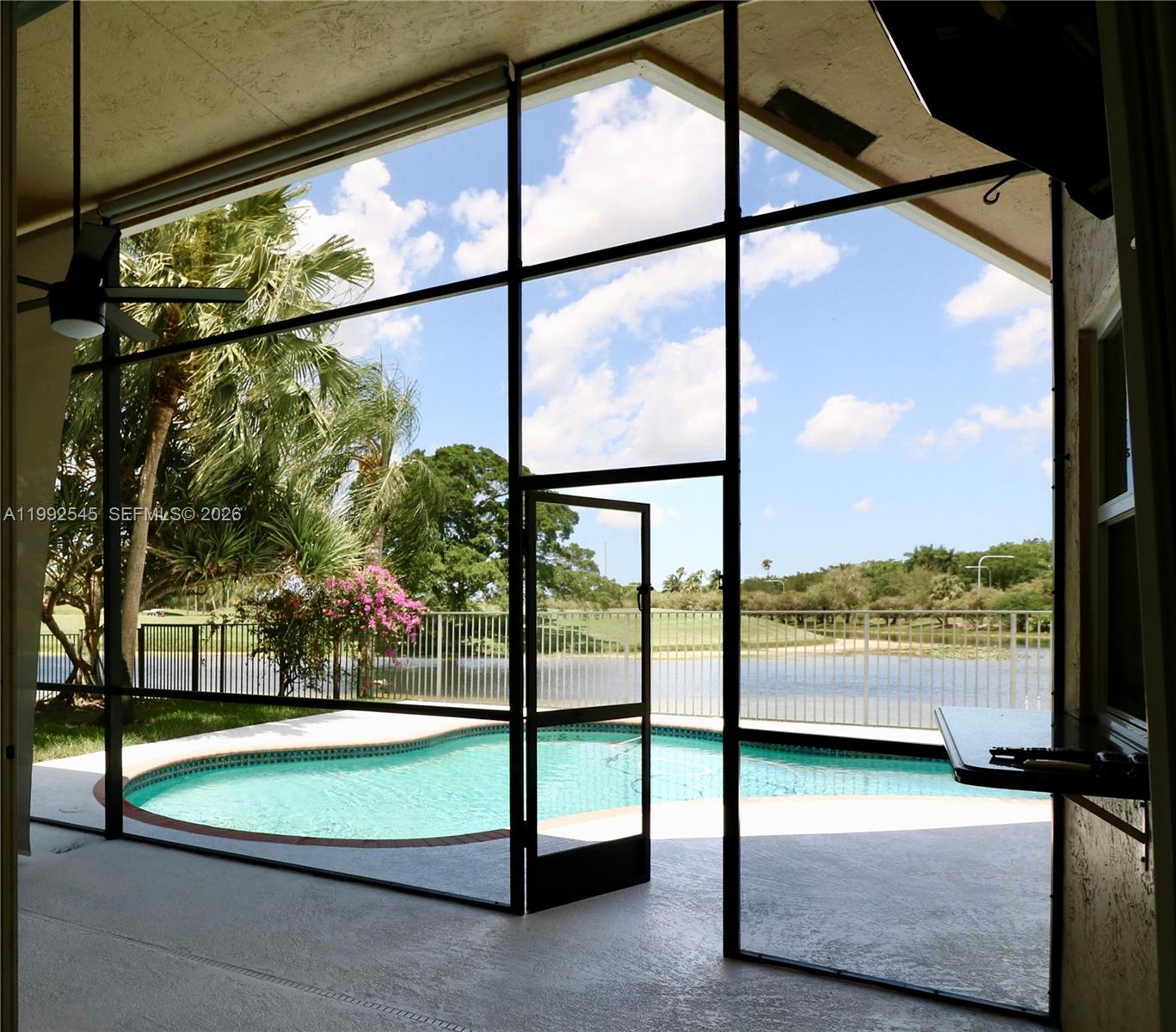 2686 Palmer Place Weston, FL 33332 - Photo 25 of 42 Screened porch from living/dinning to bar/kitchen & pool