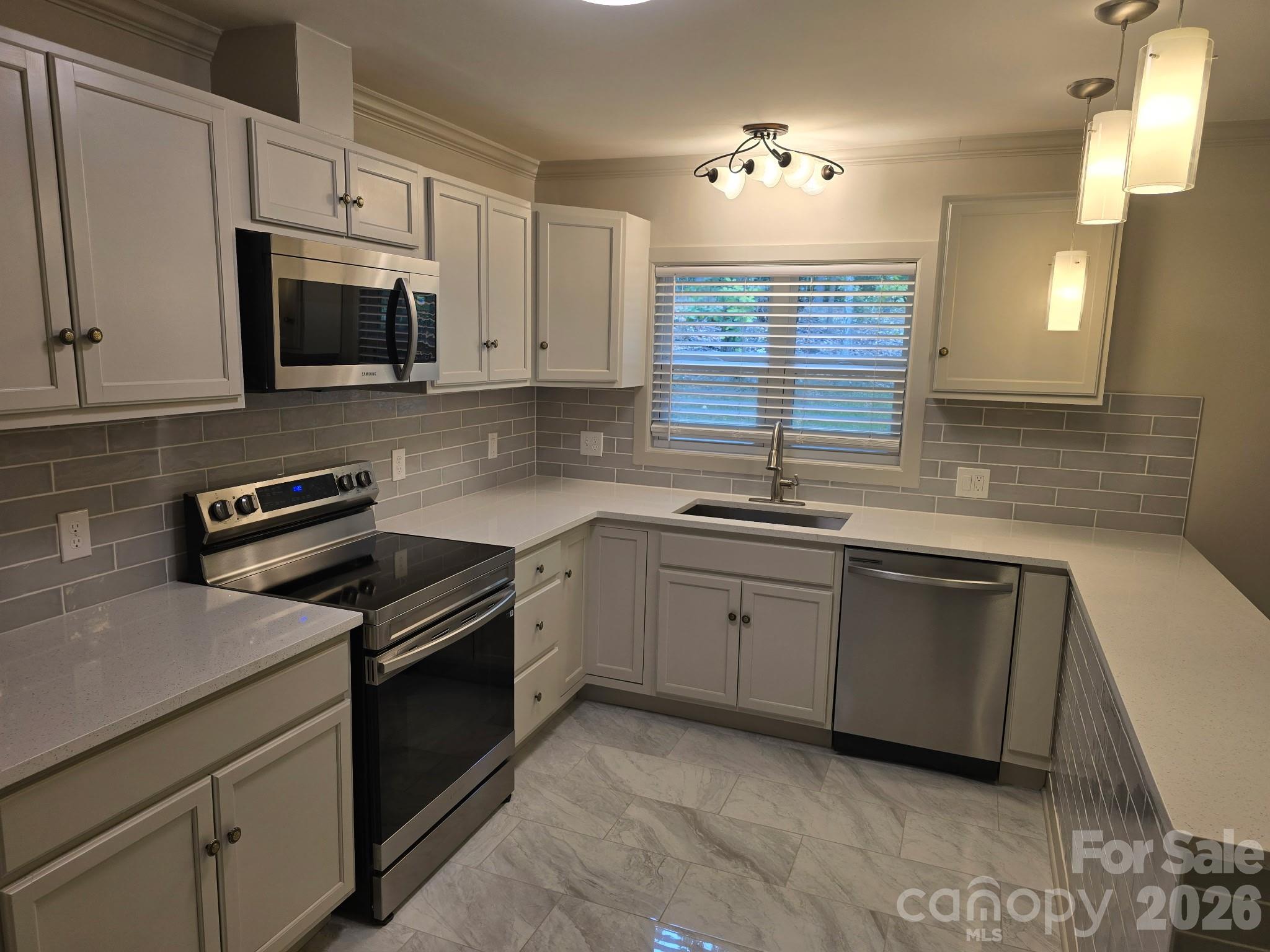 126 Sunset Drive Chester, SC 29706 - Photo 9 of 31 a kitchen with granite countertop cabinets stainless steel appliances a sink and a window