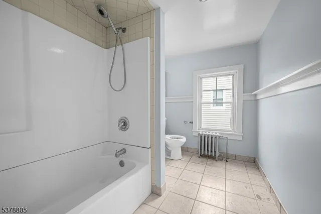 a bathroom with a granite countertop sink a toilet and shower