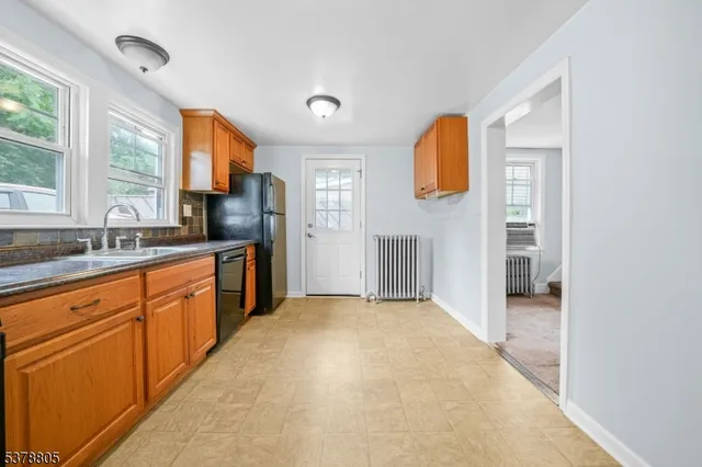 a large kitchen with a sink and cabinets