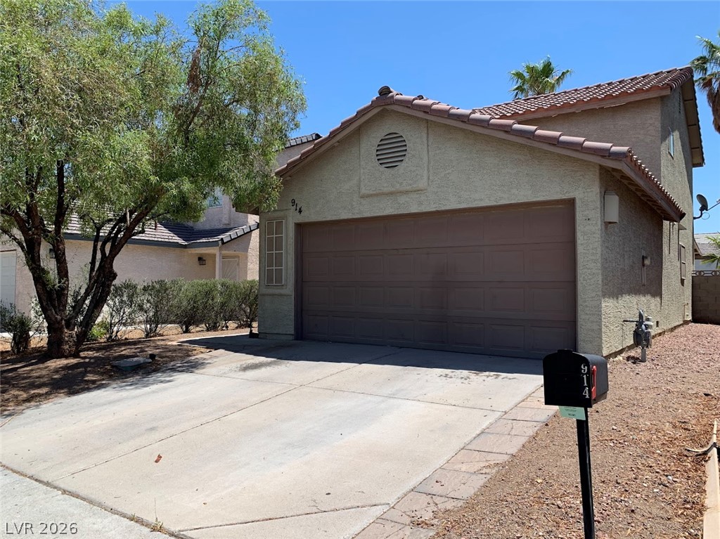 914 Scarlet Ridge Drive Las Vegas, NV 89128 - Photo 1 of 25 Concrete driveway leads to the attached garage of this charming residence.