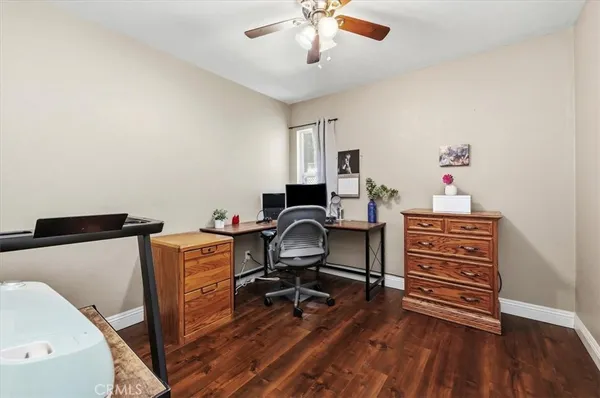 a view of a workspace with furniture and wooden floor
