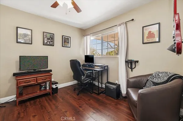 a living room with furniture and a flat screen tv with wooden floor
