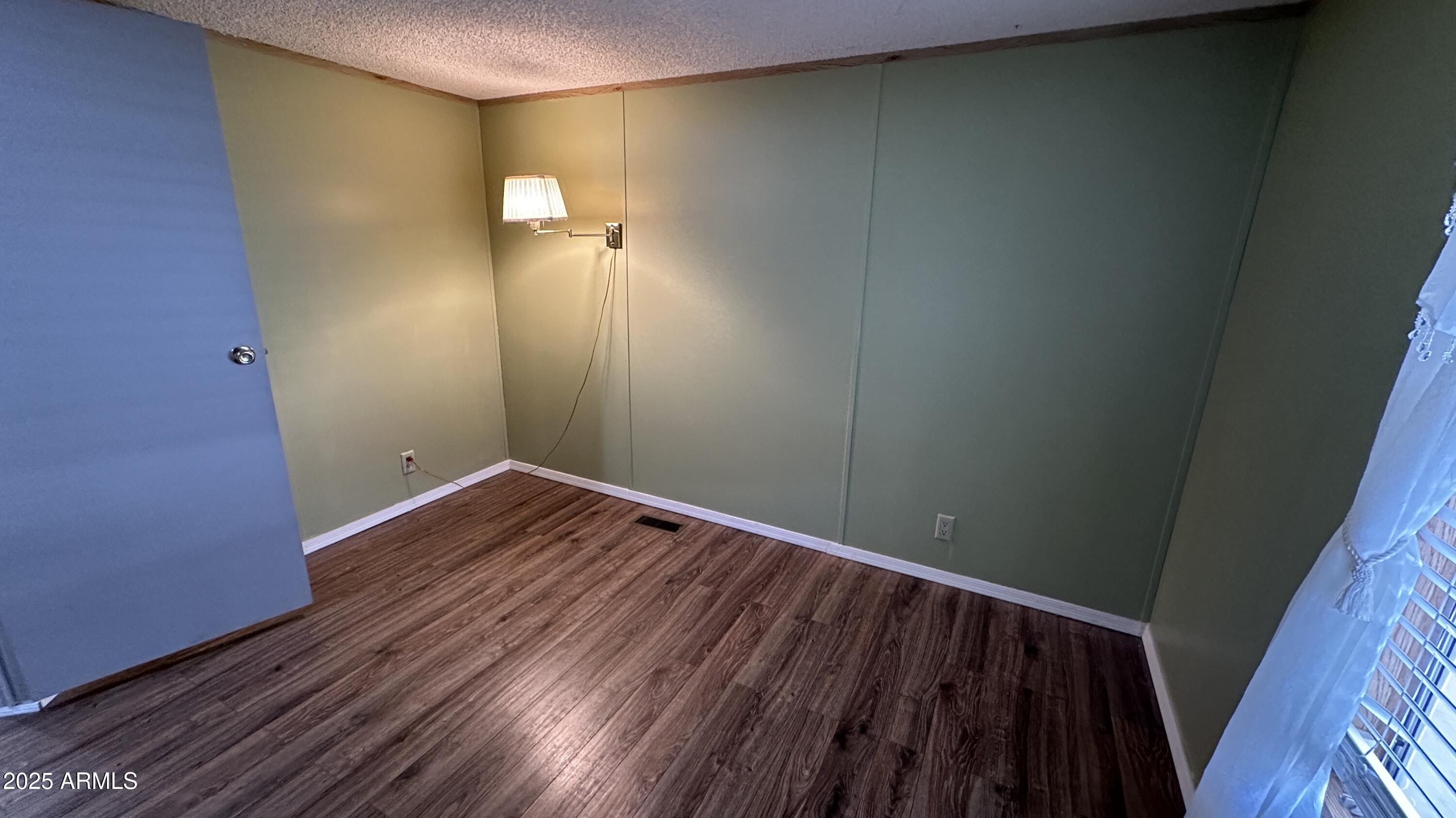 834 South Meridian Road, Unit 105 Apache Junction, AZ 85120 - Photo 19 of 48 a view of a room with wooden floor and brick wall