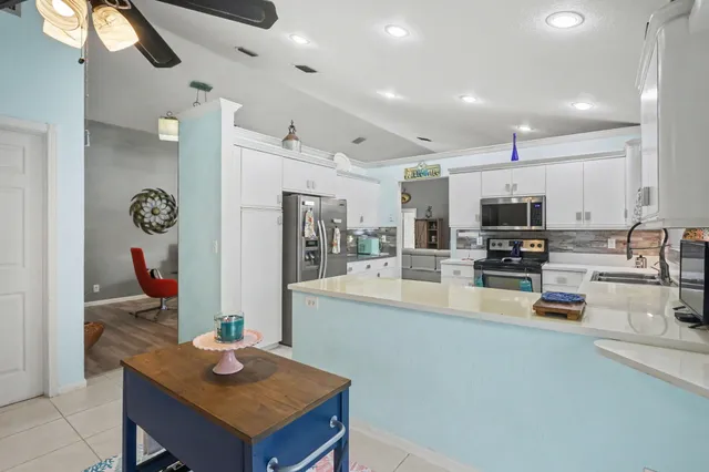 a kitchen with a sink a stove and a refrigerator