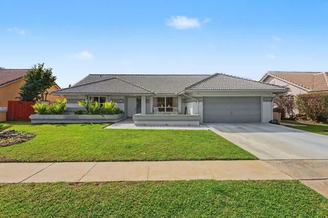 a front view of a house with a garden