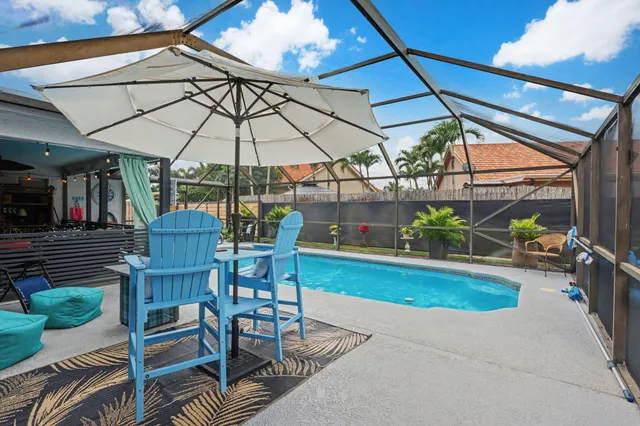 a dining room with furniture a floor to ceiling window and a ceiling fan