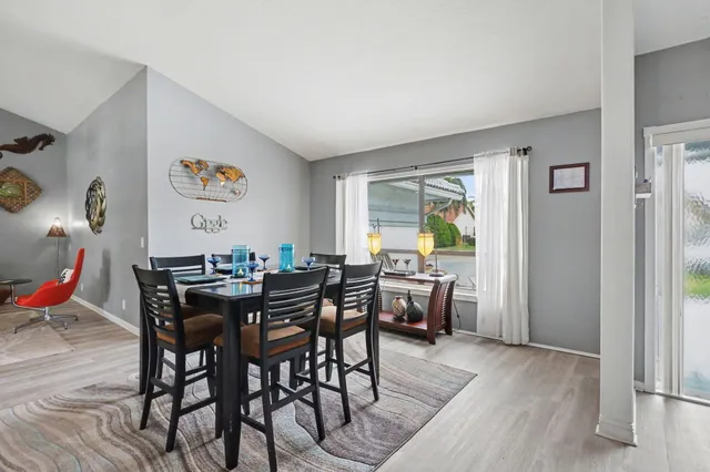 a view of a dining room with furniture and a wooden floor