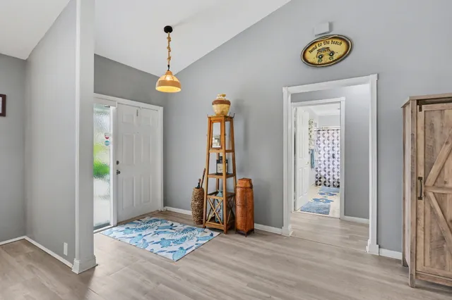 a view of an entryway with wooden floor