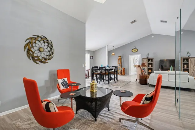 a living room with furniture and wooden floor