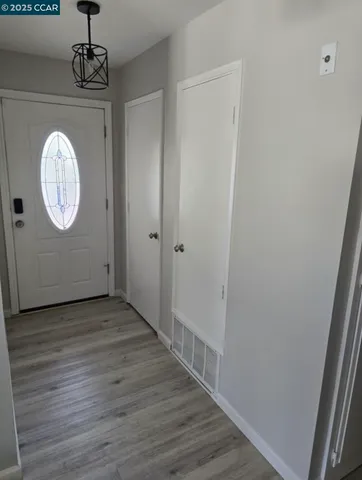 a view of a hallway with wooden floor