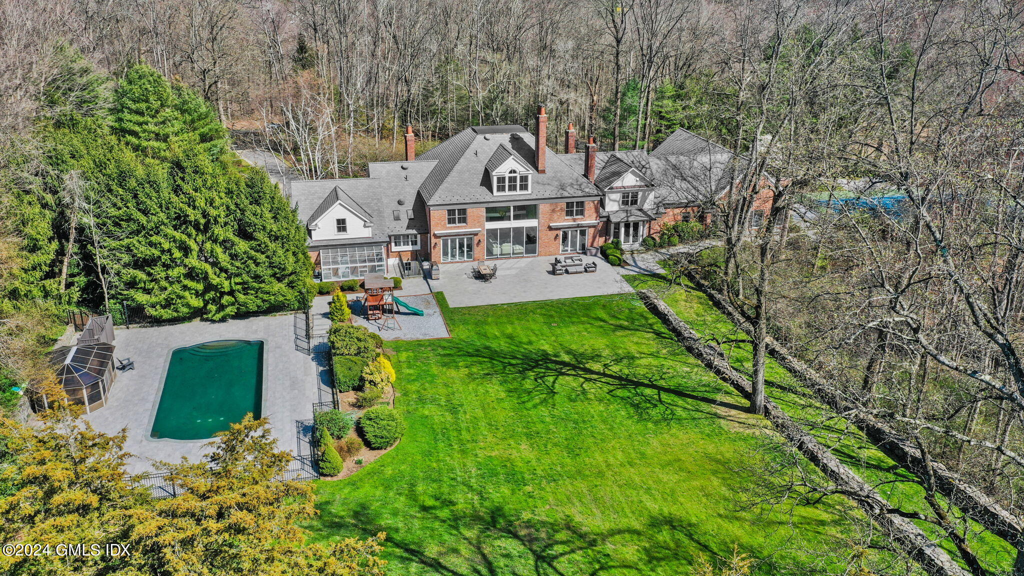 24 Highland Farm Road Greenwich, CT 06831 - Photo 1 of 34 an aerial view of a house with a yard