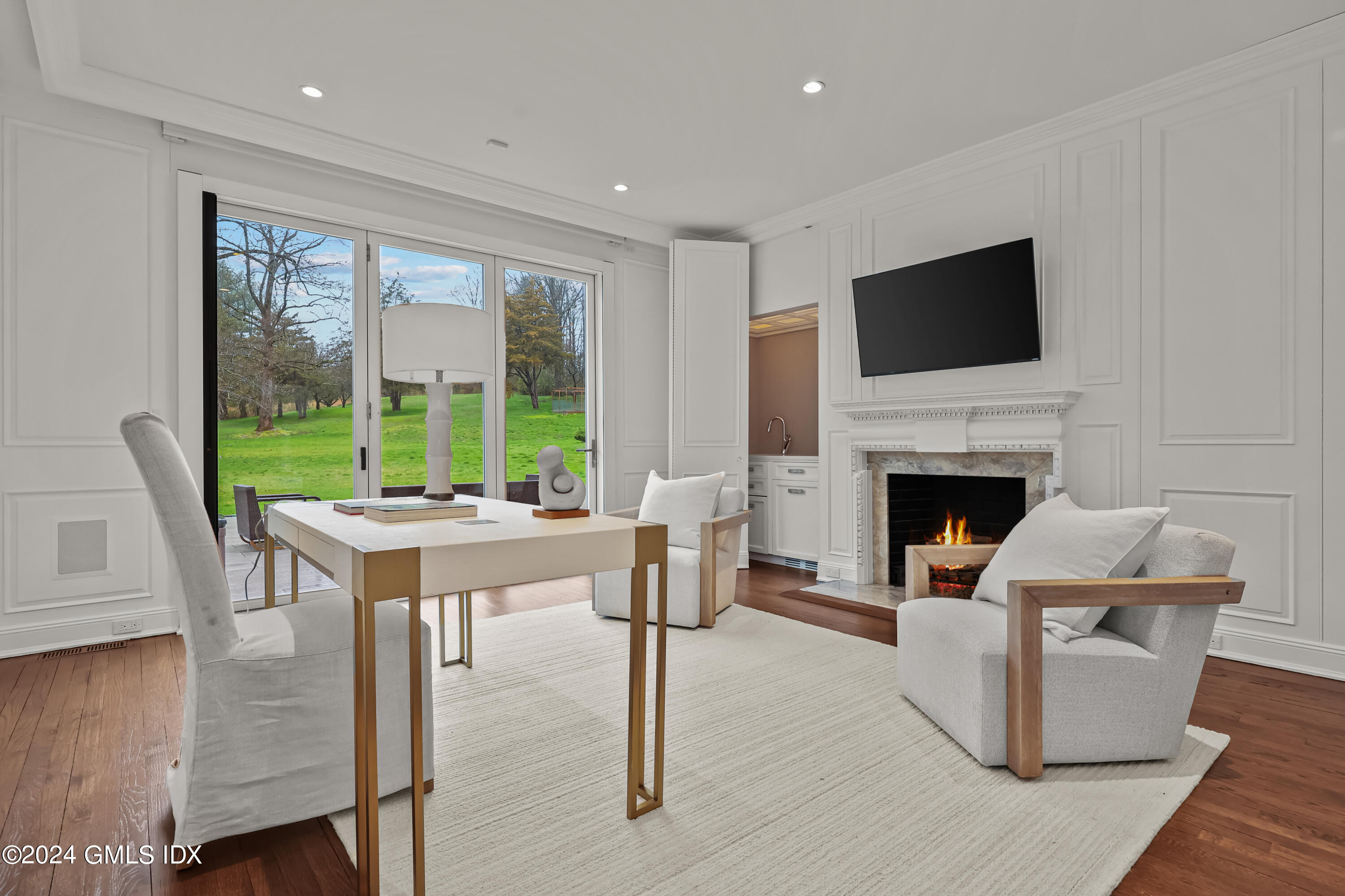 24 Highland Farm Road Greenwich, CT 06831 - Photo 15 of 34 a living room with furniture a fireplace and a flat screen tv