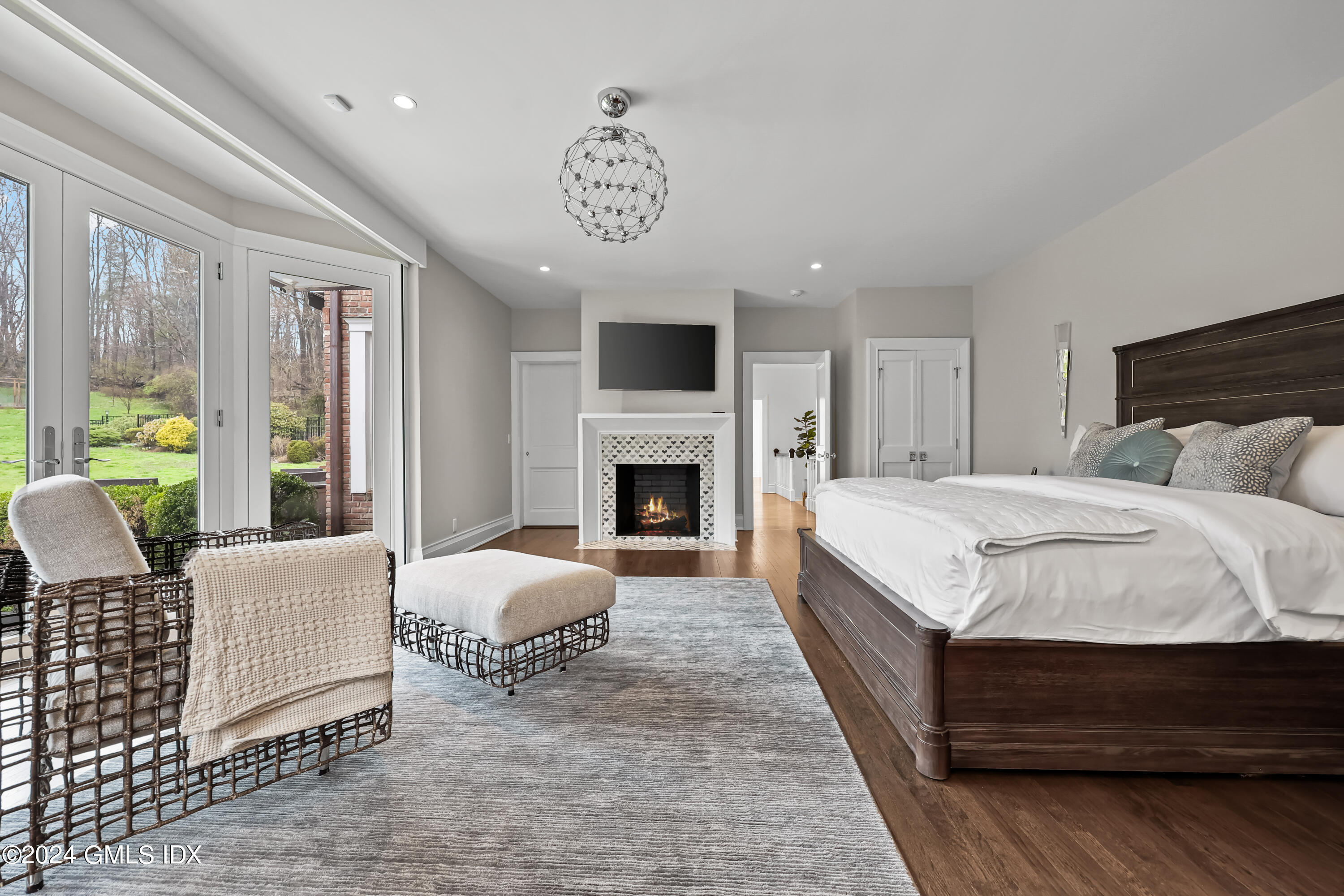 24 Highland Farm Road Greenwich, CT 06831 - Photo 16 of 34 a spacious bedroom with a bed and a fireplace