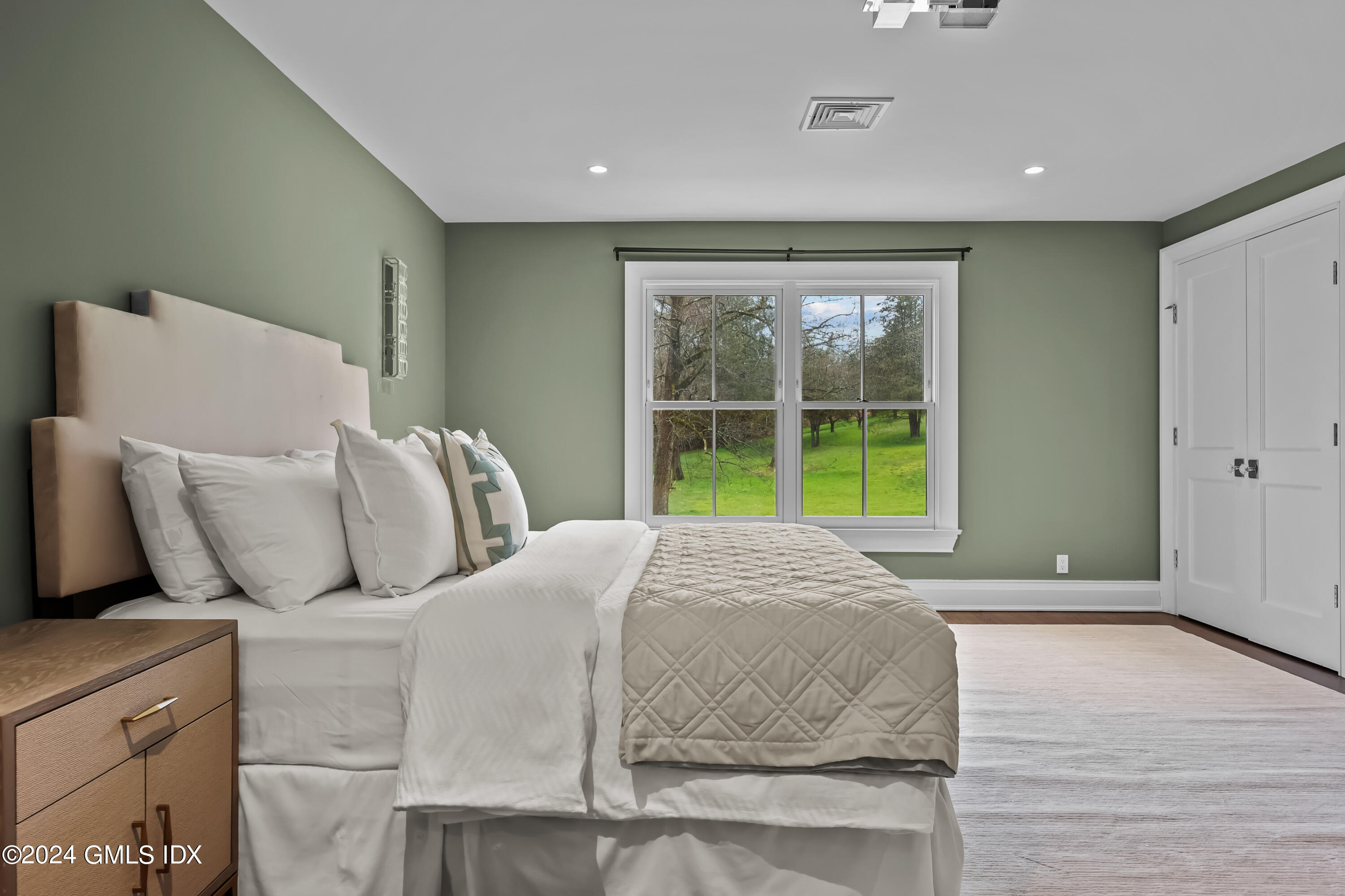 24 Highland Farm Road Greenwich, CT 06831 - Photo 18 of 34 a large bed sitting in a bedroom next to a window