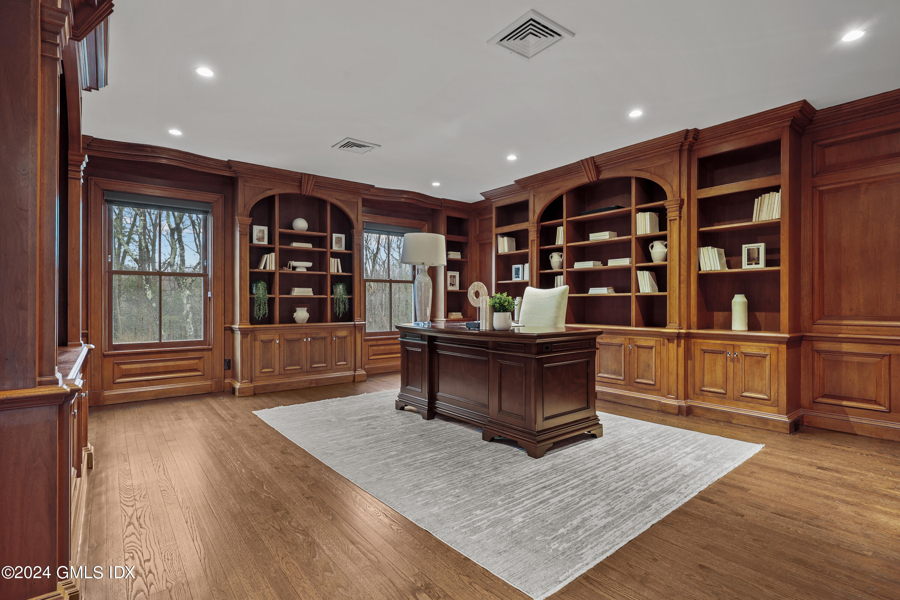 24 Highland Farm Road Greenwich, CT 06831 - Photo 20 of 34 a living room with furniture a rug and a bookshelf