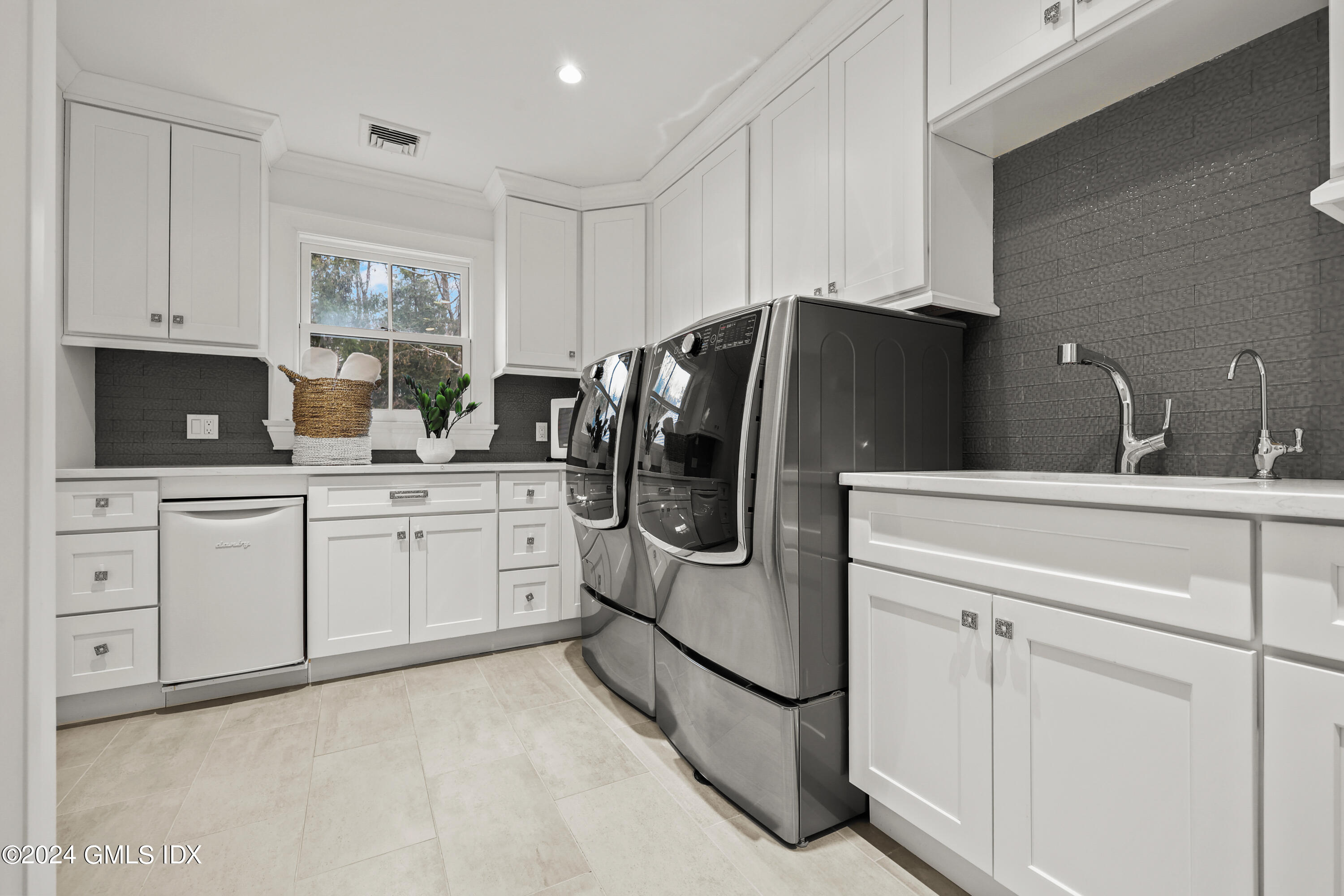 24 Highland Farm Road Greenwich, CT 06831 - Photo 21 of 34 a kitchen with white cabinets and stainless steel appliances