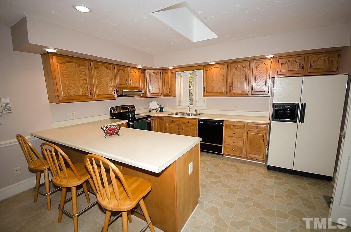 2176 Burlington Road Roxboro, NC 27573 - Photo 4 of 25 a kitchen with a stove a sink and a refrigerator