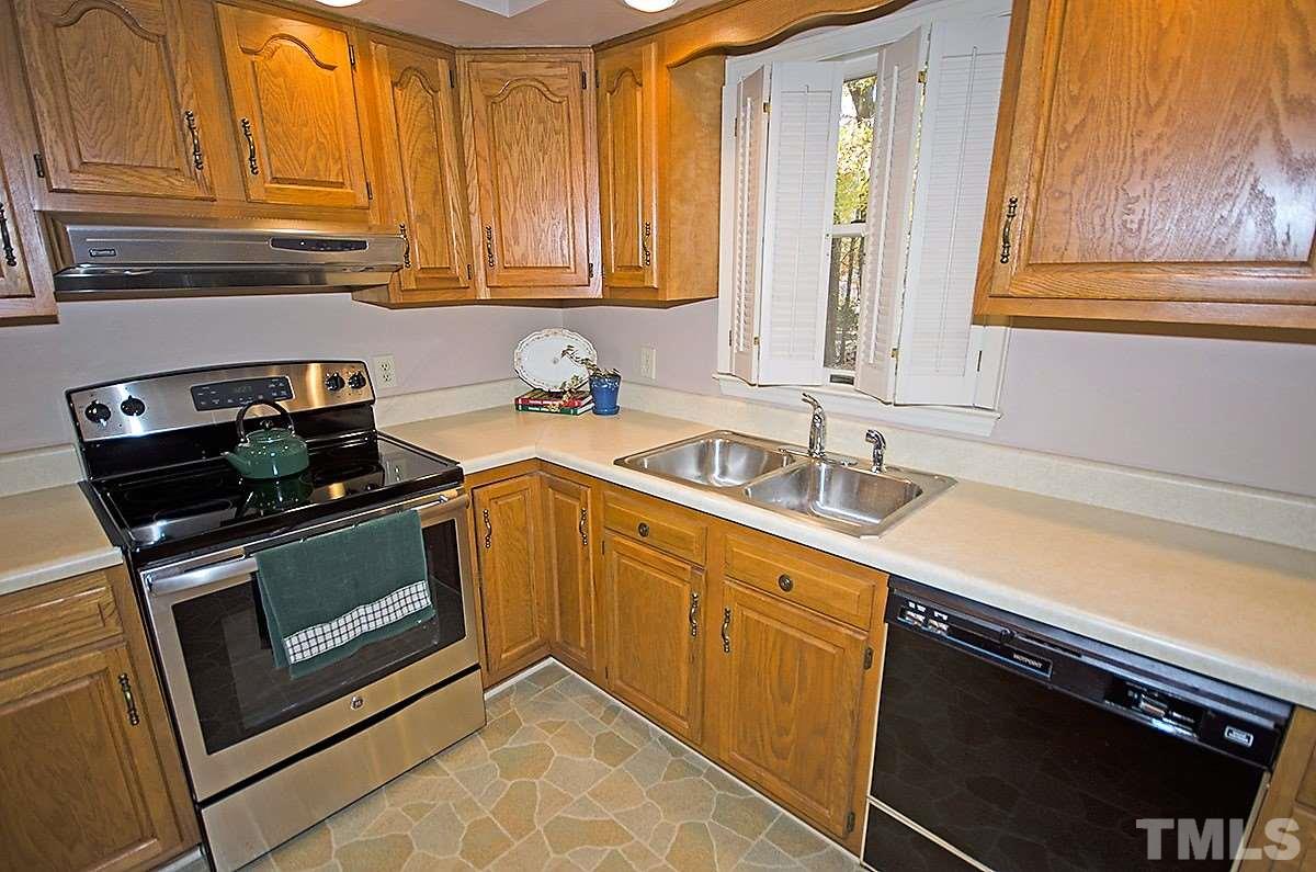 2176 Burlington Road Roxboro, NC 27573 - Photo 5 of 25 a kitchen with a sink stove and cabinets