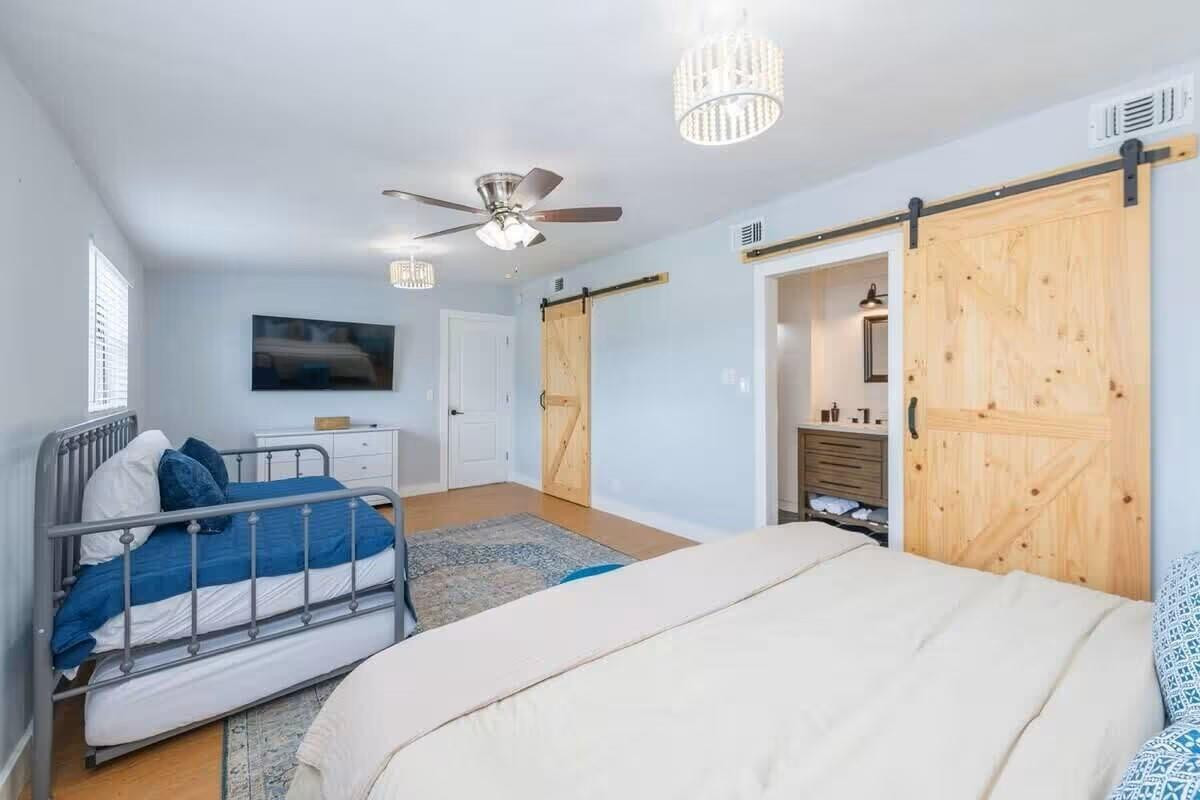 3762 Catalina Road West Palm Beach, FL 33410 - Photo 11 of 29 a bedroom with a bed window and a flat screen tv