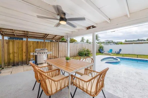 a view of a patio with a table and chairs
