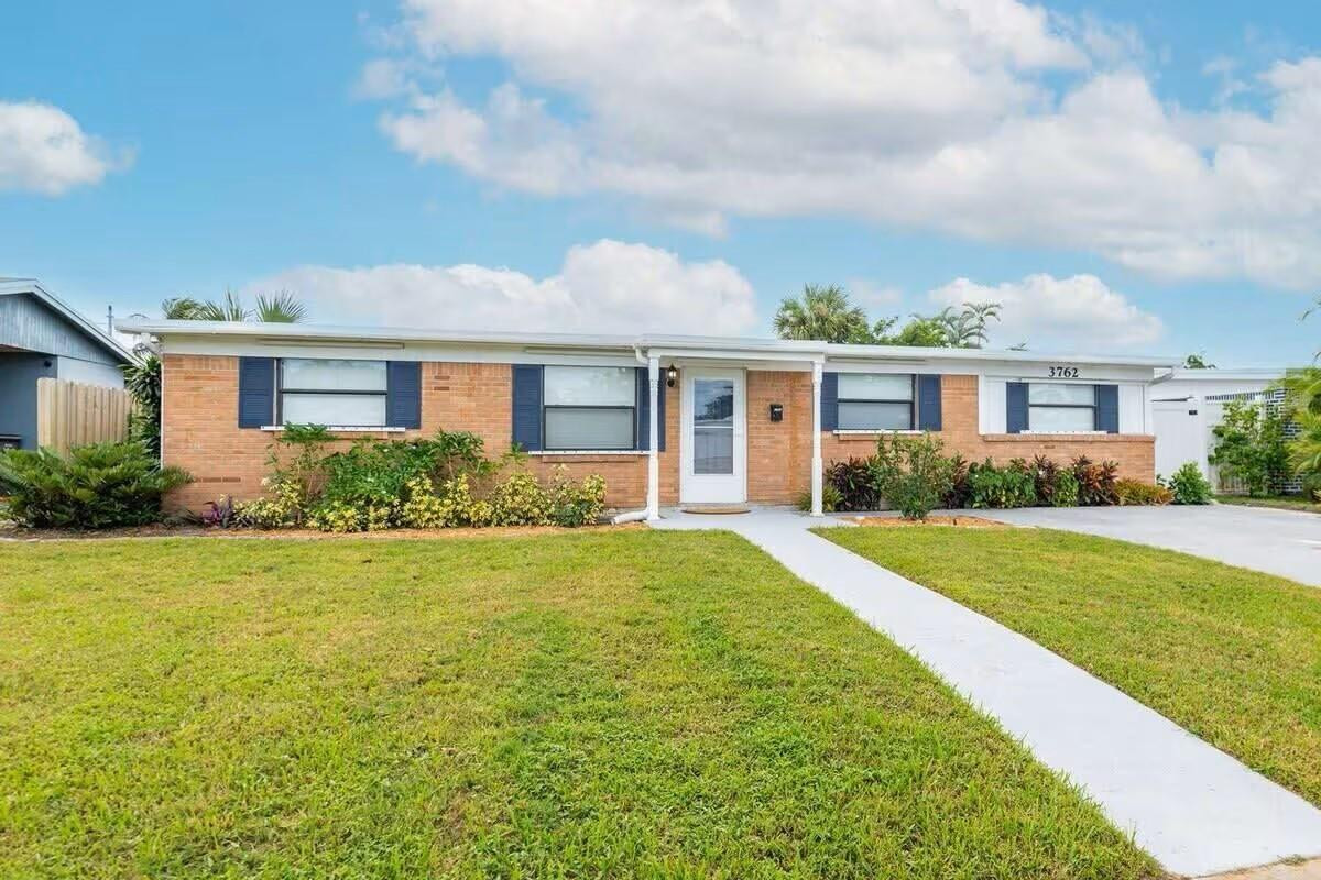 3762 Catalina Road West Palm Beach, FL 33410 - Photo 29 of 29 a front view of house with yard and green space