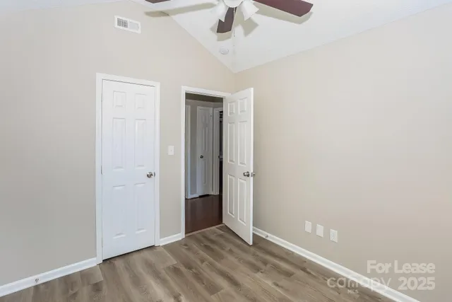 an empty room with a empty space and a ceiling fan