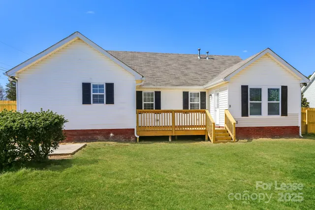 a front view of a house with a yard table and chairs