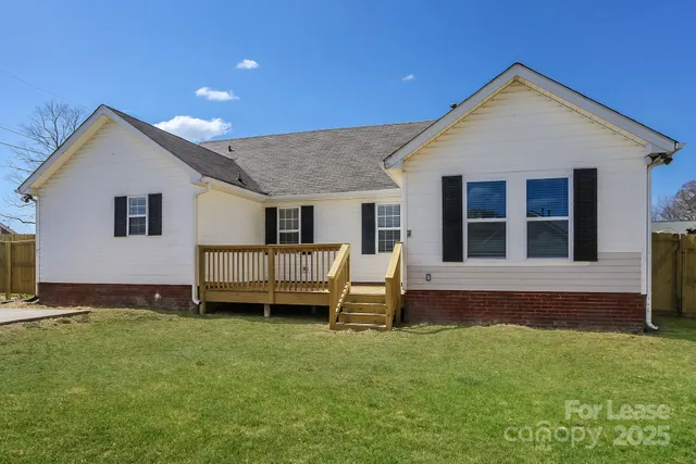 a front view of a house with a garden and yard