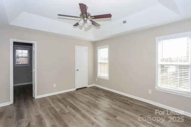 a view of a livingroom with a ceiling fan and window