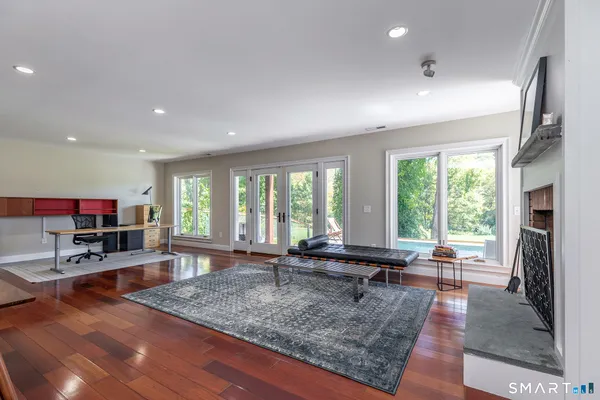 a living room with fireplace furniture and a large window