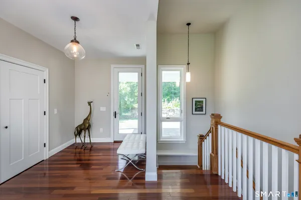 a view of a room with wooden floor and stairs