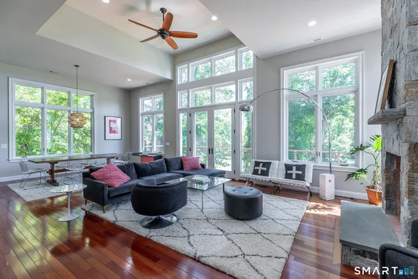 a living room filled with furniture and a large window