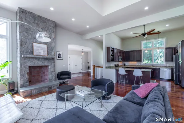 a living room with furniture and kitchen view