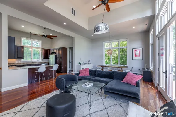 a living room with furniture potted plant and a window