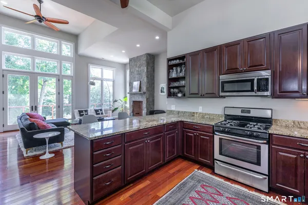a kitchen with stainless steel appliances wooden cabinets and a stove top oven