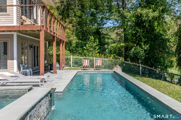 a view of a house with swimming pool and sitting area