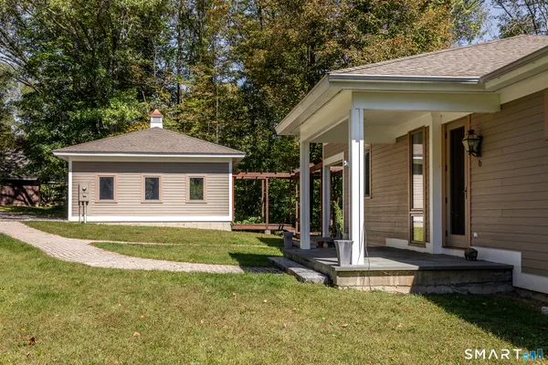 a view of a house with a yard and potted plants