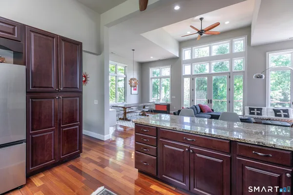 a kitchen with wooden cabinets and refrigerator