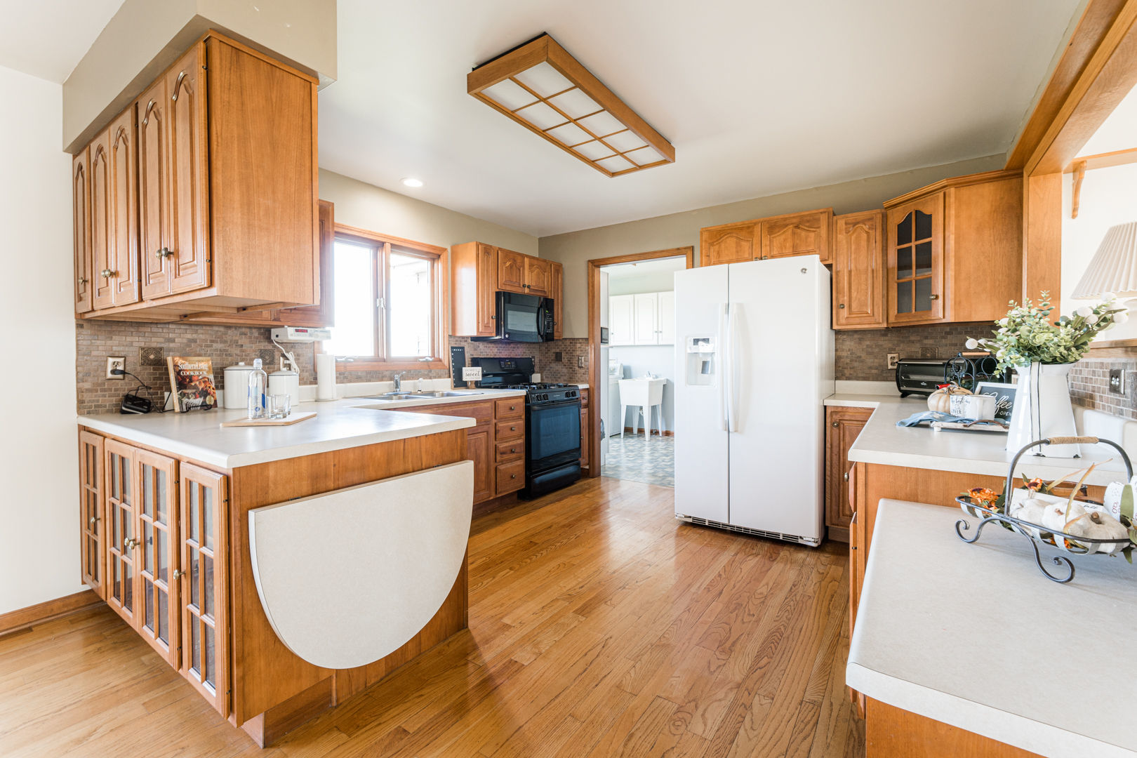 49W170 Lasher Road Big Rock, IL 60511 - Photo 11 of 33 a kitchen with a refrigerator a stove a sink dishwasher and wooden cabinets with wooden floor