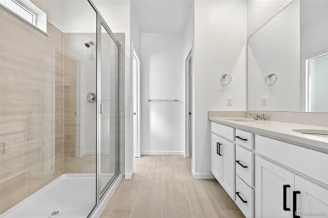 a bathroom with a granite countertop shower sink and mirror
