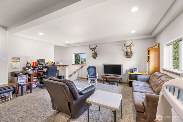 a view of a room with furniture and a ceiling fan