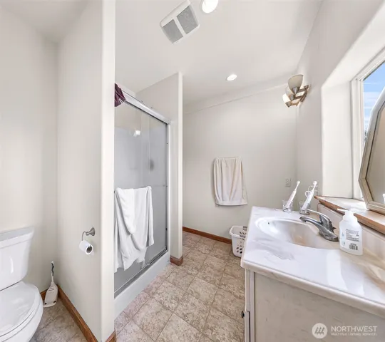 a living room with furniture a flat screen tv and a window