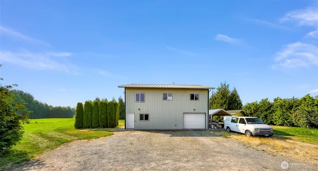 a view of a yard with a house in the background