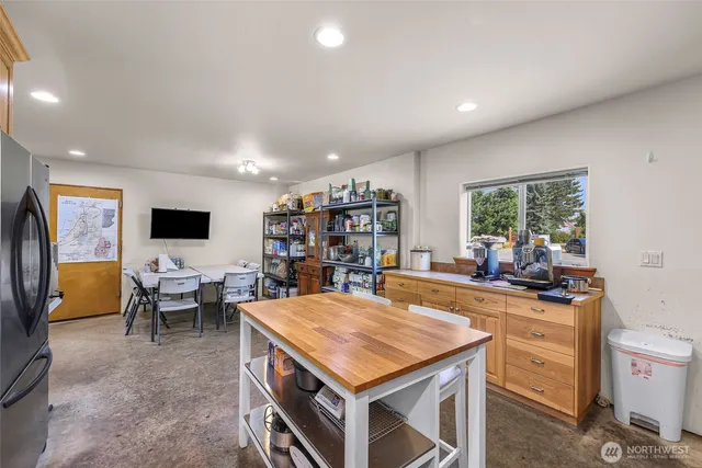 a living room with lots of furniture and kitchen view