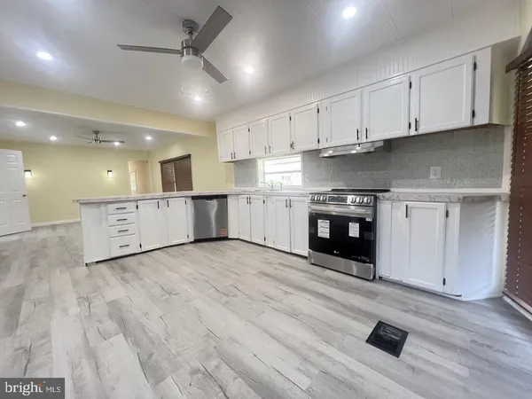a view of a kitchen with a sink and a stove top oven