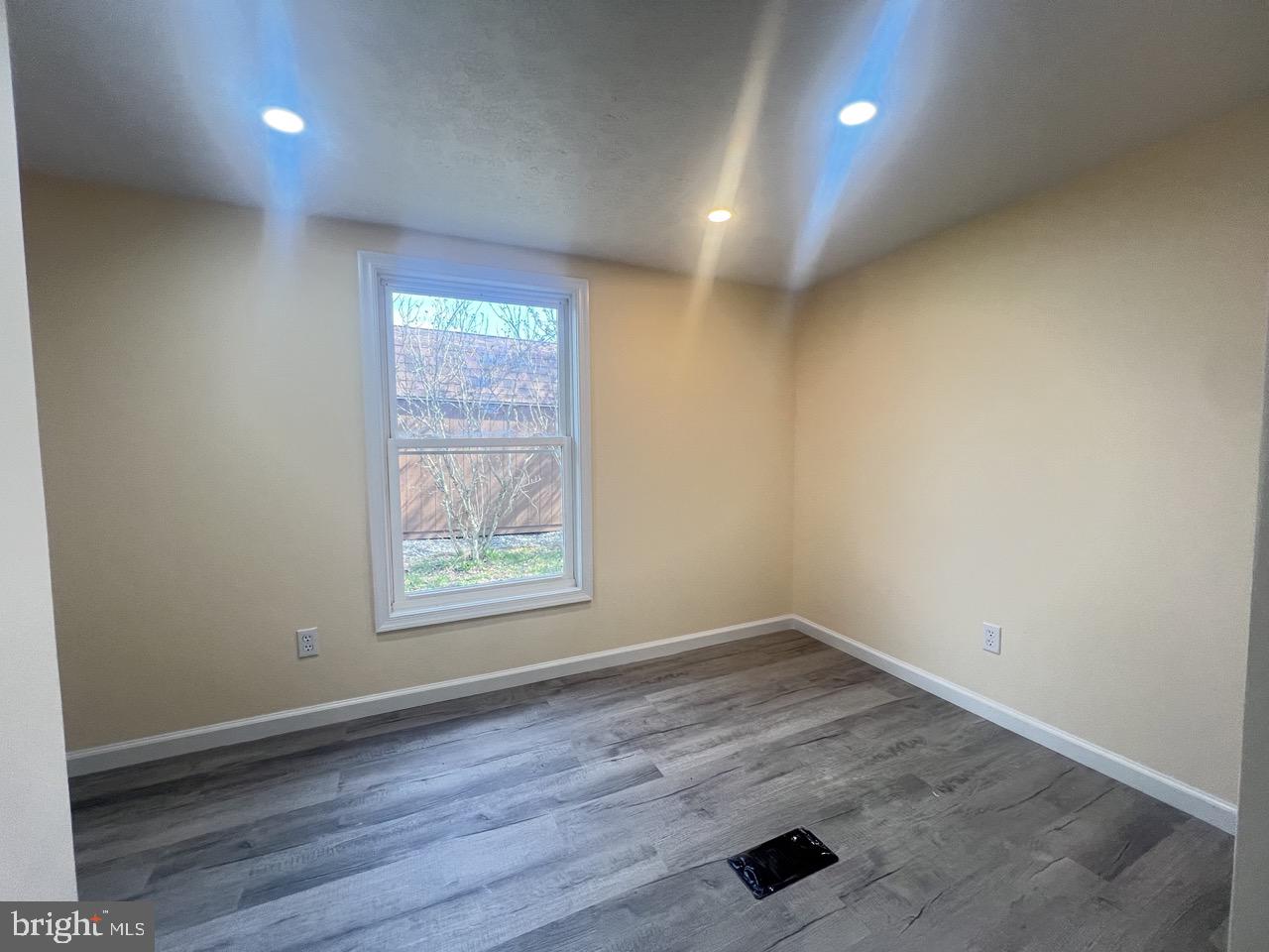 202 Mt Laurel Drive Ridgeley, WV 26753 - Photo 11 of 38 an empty room with wooden floor and windows